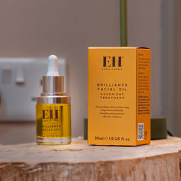 Emma Hardie Brilliance Facial Oil bottle and packaging on a wooden surface