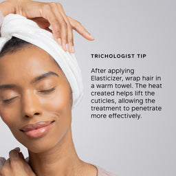 A woman with her hair wrapped in a white towel is shown against a light gray background, with text reading 'TRICHOLOGIST TIP' and an instruction about applying Elasticizer and wrapping hair in a warm towel.