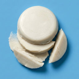 Stack of white macaron cookies on a blue background