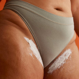 a closeup of Frank Body Glycolic Body Scrub applied