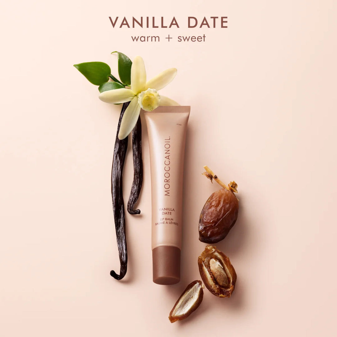 Moroccanoil Vanilla Date hair product with vanilla bean, date, and flower on a light pink background