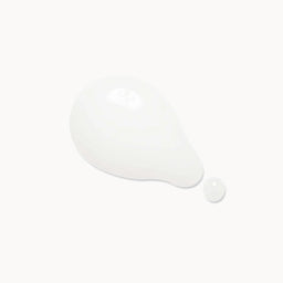 A glossy white teardrop-shaped droplet of cream or serum with a small separate droplet beside it, centered on a very light off-white background.
