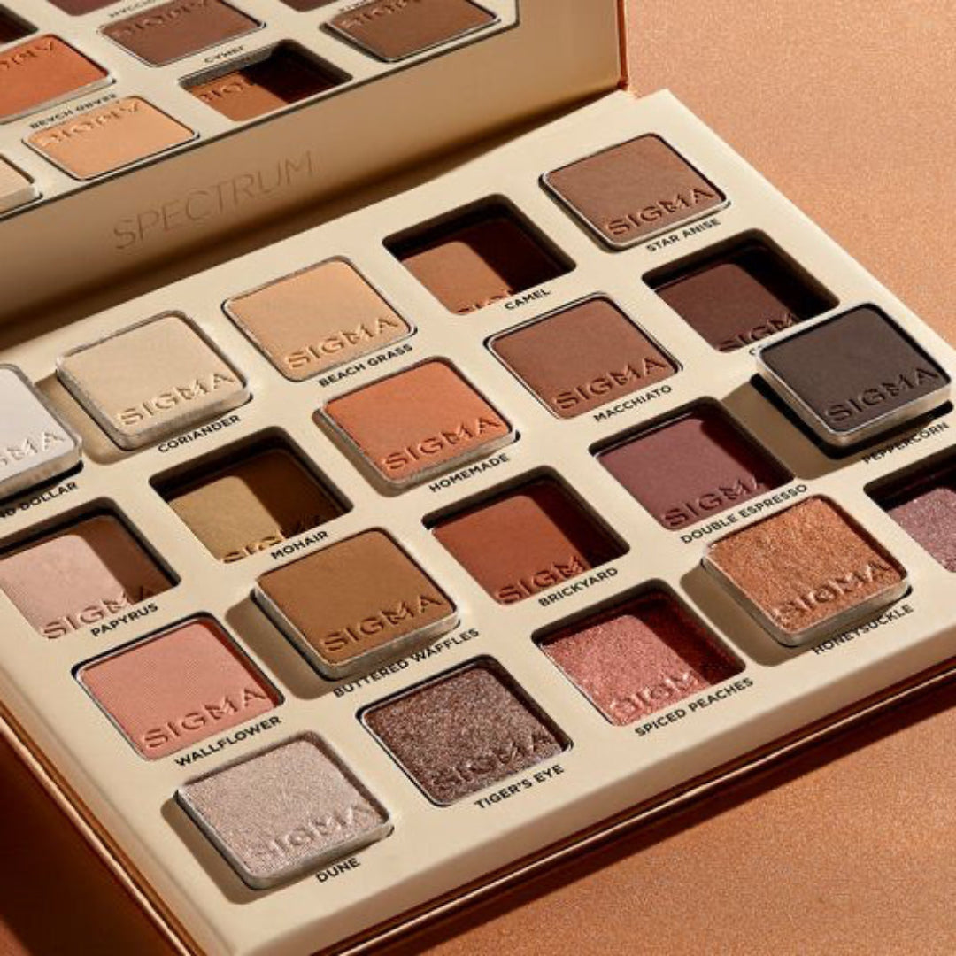 Sigma eyeshadow palette with a variety of colors on a beige background