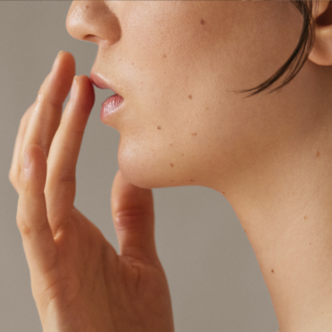 Close-up of a person's face with a neutral background