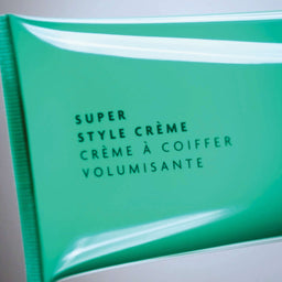 a closeup of a R+Co Bleu Super Style Creme tube