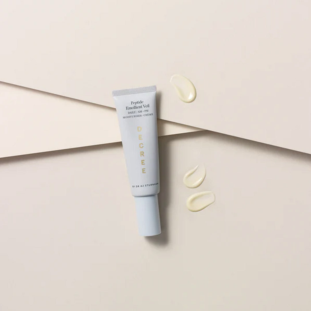 Decree AM Essentials with three drops of cream next to the tube