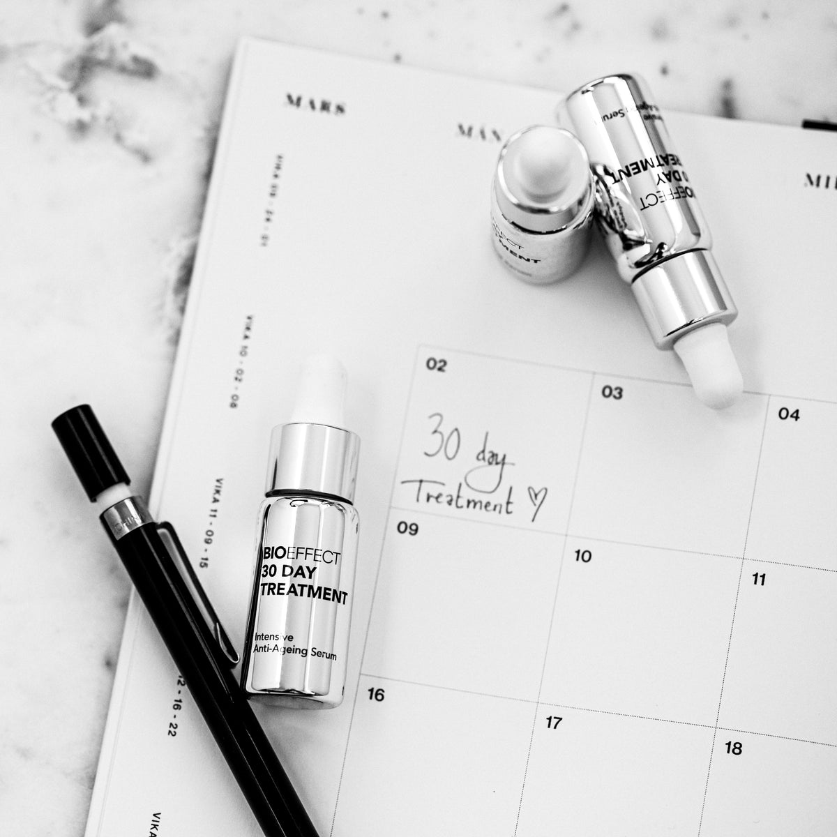 three bottles of BIOEFFECT 30 Day Treatment on a calendar 