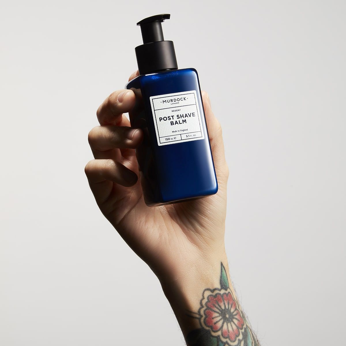 a hand holding the bottle into the air