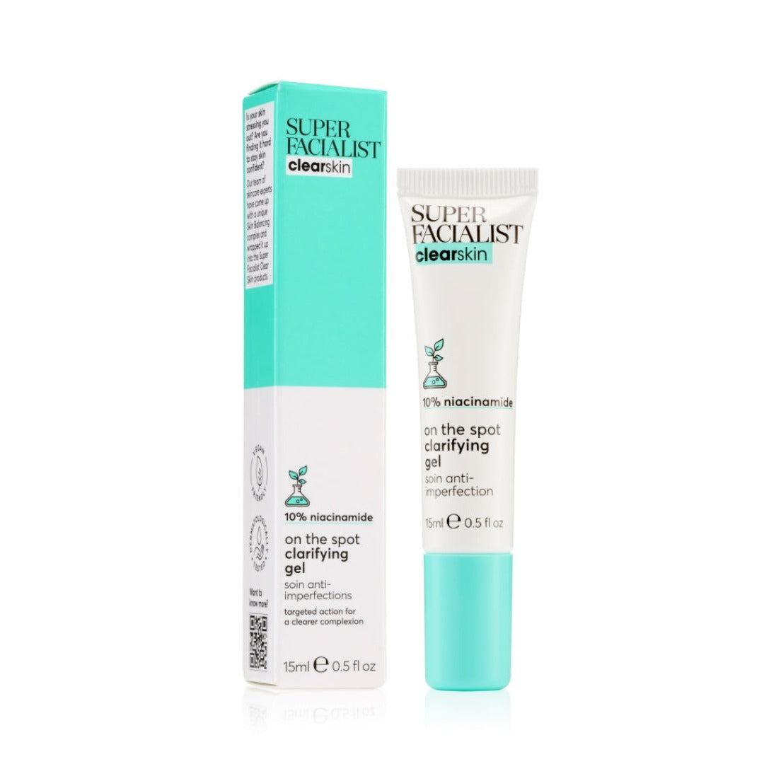 Clear skin spot gel tube with carton packaging in front of white background